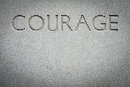 The Word Courage Engraved Into Rock