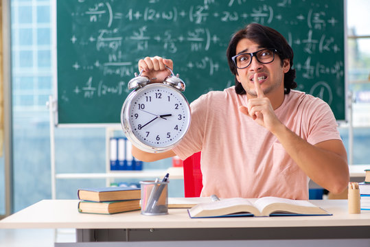 Young male student in the classroom 