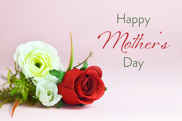 Happy Mothers Day card. Bunch of artificial flowers on pink background