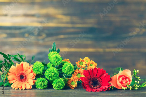 Mothers Day flowers on wooden background with copy space