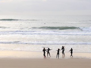 surfer people carrying surfboard on an ocean beach