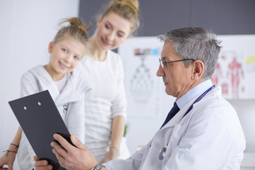 Little girl with her mother at a doctor on consultation