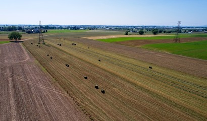 Fototapeta na wymiar Aerial View of Amish Farmers Harvesting there Crops in Summer