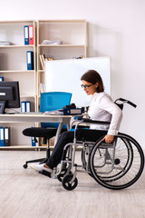 Female employee in wheel-chair at the office  