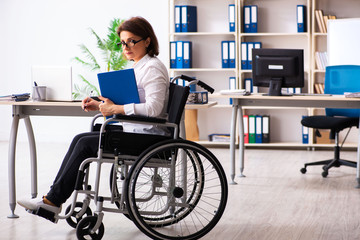 Female employee in wheel-chair at the office  