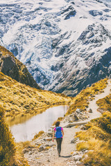Hiking girl in New Zealand Mt Cook nature mountain. Alone hiker walking on popular trail Mueller Hut route in Mount Cook National Park mountains.