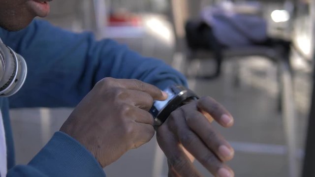 Youth,technology,modernity.Balck african man using smart watch-slow motion