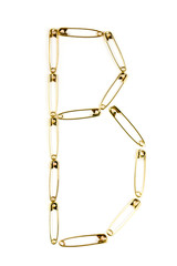 The letter "B" in gold colored safety pins