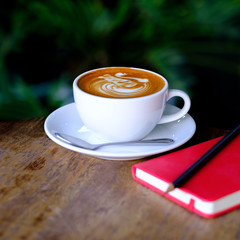 hot mocha coffee with red notebook