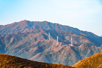 The mountain wind turbines in the sunrise and sunset in the sea of clouds