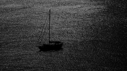 silhouette boat in the sea with black and white image in minimalist concept