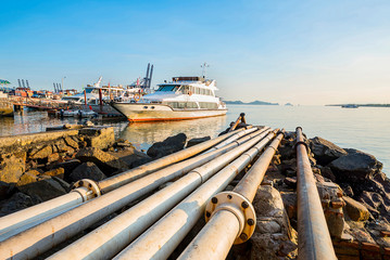 Industrial harbor cruise ships and pumping discharge pipes