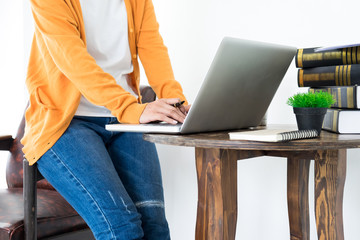 Attractive Young beautiful entrepreneur Woman smiling and looking at laptop screen, Working from Home.