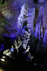 beautiful illuminated multicolored stalactites from karst Reed Flute cave In the cave. Guilin Guangxi China