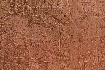 Blurred abstract background. The texture of the painted concrete rough surface with cracks and holes is light brown in color. Cropped shot, horizontal, place for text, nobody. The concept of repair 