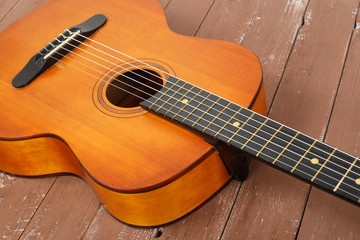 Fototapeta na wymiar Musical instrument - Fragment retro russian acoustic guitar wood background