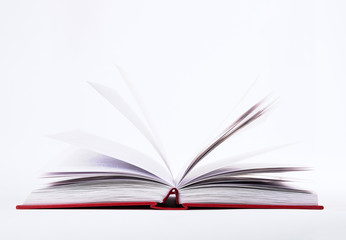 Closeup view of open book with pages in red hard cover, isolated on white background