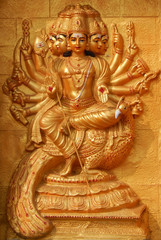wall art of Indian Hindu Goddess Durga with weapons to end evil ,sit on  peacock,in blessing pose in a temple