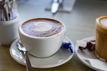 Cup of cappuccino on a table, close up.