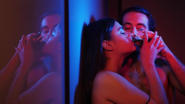 Young Hot lovers in the dark,flirting drinking alcohol.Attraction,sex