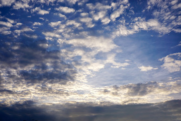 Background and texture of bright blue sky and cotton clouds with sun lights on afternoon summer.