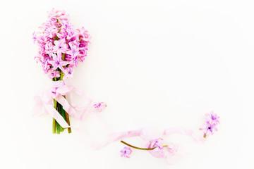 Floral bouquet of hyacinth flowers, petals and tapes on white background. Flat lay, top view.