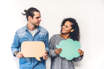 Two friends holding a speech bubble icon together