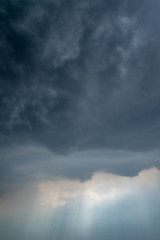 Fototapeta na wymiar Light in the Dark and Dramatic Storm Clouds background