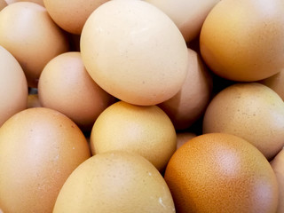 Closeup and crop of heap brown chicken eggs.