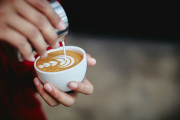 Barista Pouring a cup of latte art