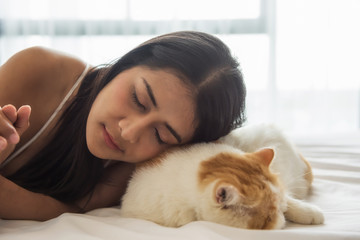 Asian woman sleep with exotic shorthair cat