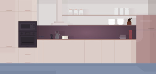 Cozy modern kitchen interior with appliances, fridge, stove.