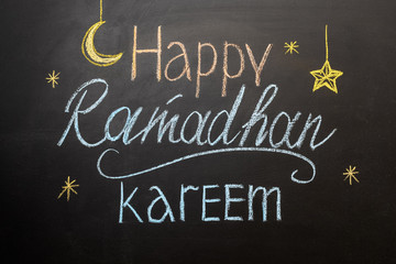 Fototapeta na wymiar Happy Ramadan Kareem text on chalkboard