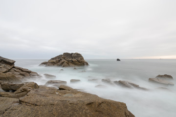 Fototapeta na wymiar Longexposure of big Rock in the Atlantic Ocean at high tide, France, Brittany, Finistere