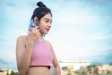 Asian woman showing a bottle of water