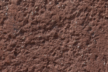 close up of red stony wall
