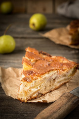 Apple pie on a wooden background, selective focus