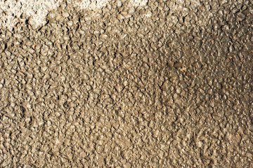 Surface of dry and wet asphalt in yellow tone