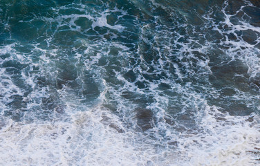 Fototapeta na wymiar Sea waves with foam top view