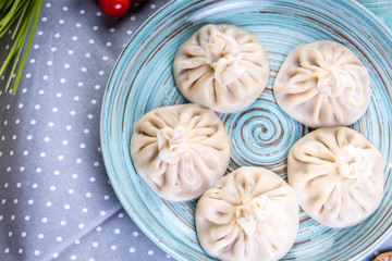 large khinkali with lamb on a plate top view.