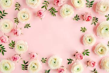 Floral background frame made of pink ranunculus and roses flower buds on pink background.  Flat lay, top view floral background.