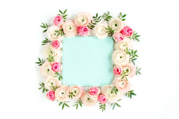 Floral pattern frame made of pink ranunculus and roses flower buds on white background with space for text.  Flat lay, top view floral background.