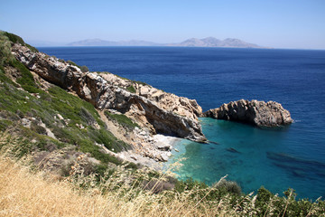 Fototapeta na wymiar island of Greece. The island of Ikaria in the Aegean sea. Turquoise, blue sea. Rocky shore. Tourism and travel around the world.