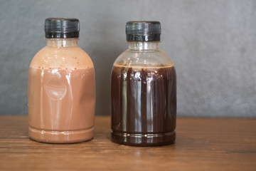 Plastic coffee bottle on wood table