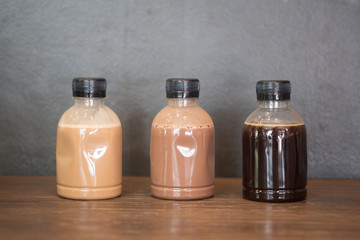 Plastic coffee bottle on wood table