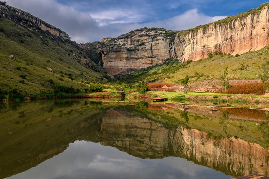 Sandstone cliffs reflecting in a dam in the Golden Gate National park in South Africa Freestate.