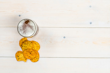 Beer with chips on wooden background. Top view. Empty space for text