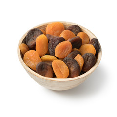 Fototapeta na wymiar Bowl with orange and brown dried apricots