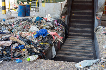 Municipal solid waste transported by belt conveyor in the waste treatment plant