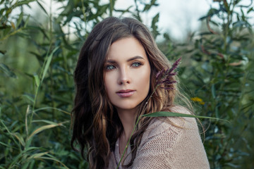 Fototapeta premium Cute young woman relaxing in summer grass